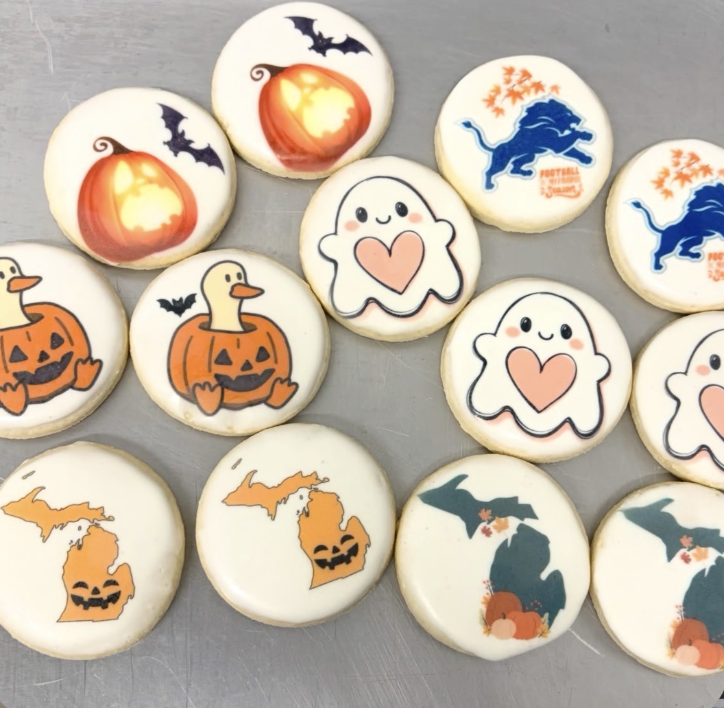 Custom printed cookies with pumpkins, friendly ghosts, Michigan shapes, and Detroit Lions designs